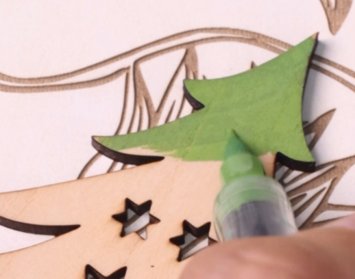 Painting laser cut wooden ornament parts with color